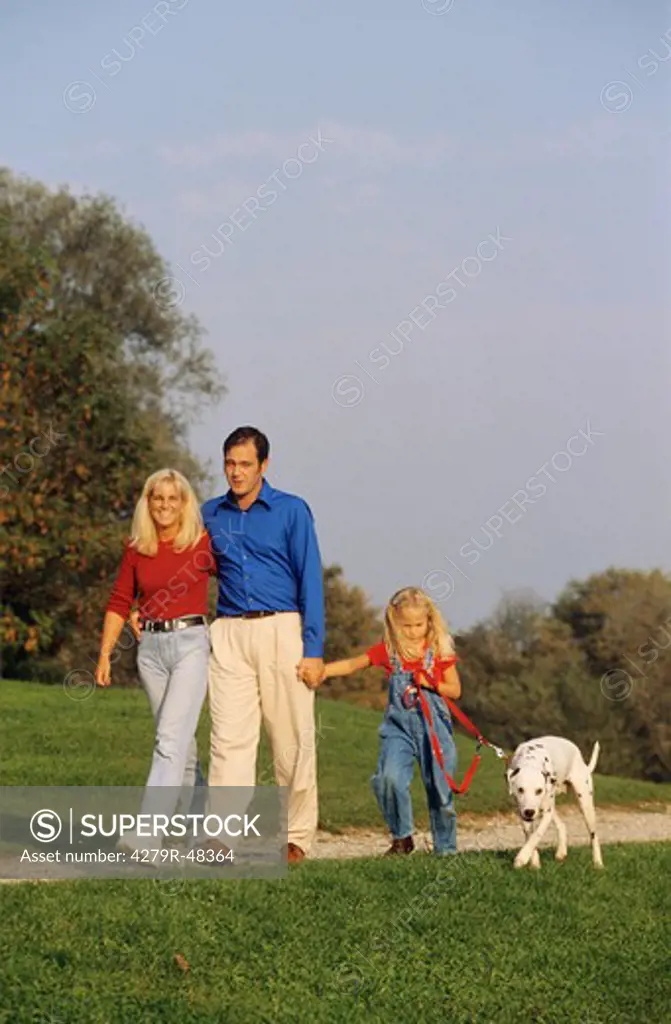 family with Dalmatian dog - walk