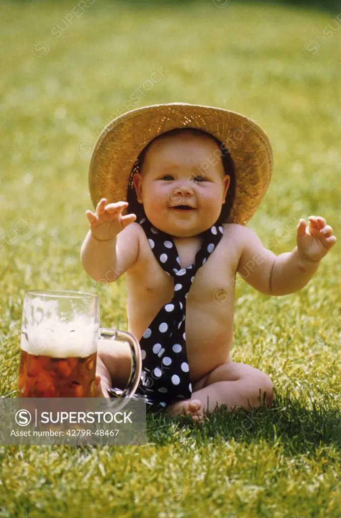 baby with hat and tie next to beer mug - naked