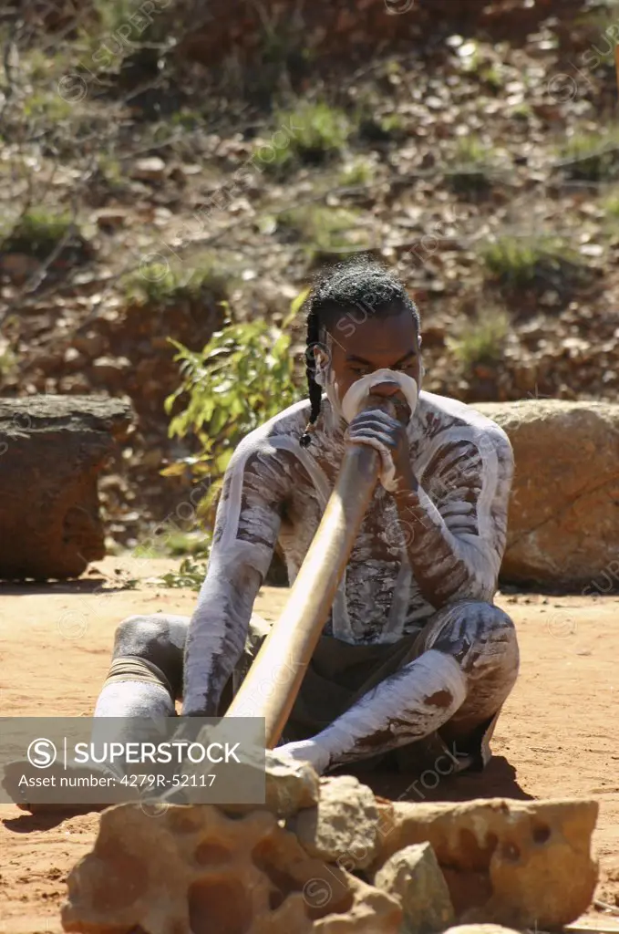 Australia , Aborigine playing with a didgeridoo