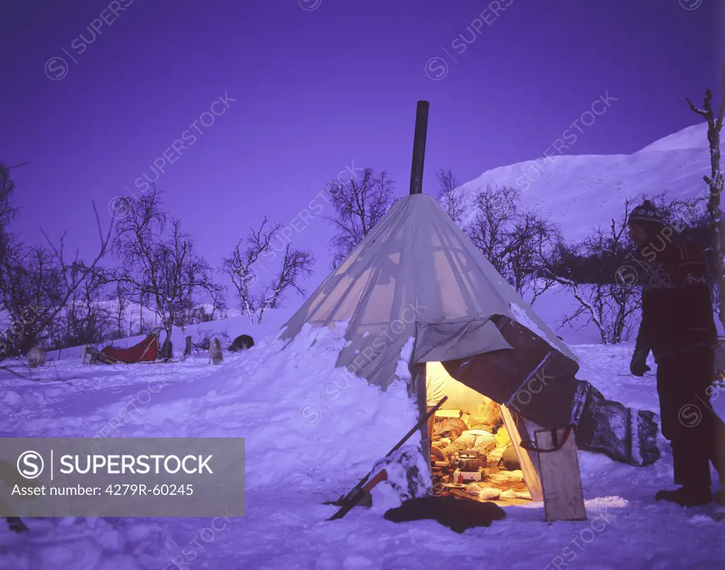 illuminated tent in the snow