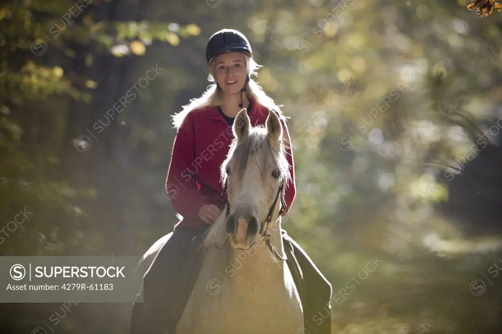 woman riding on Arabian horse