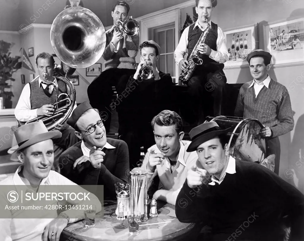 Group of men sitting in a diner with musicians behind them All persons depicted are not longer living and no estate exists Supplier warranties that th...