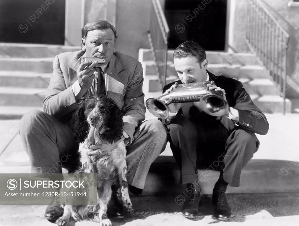 Two men playing two harmonicas with an English Setter All persons depicted are not longer living and no estate exists Supplier warranties that there w...