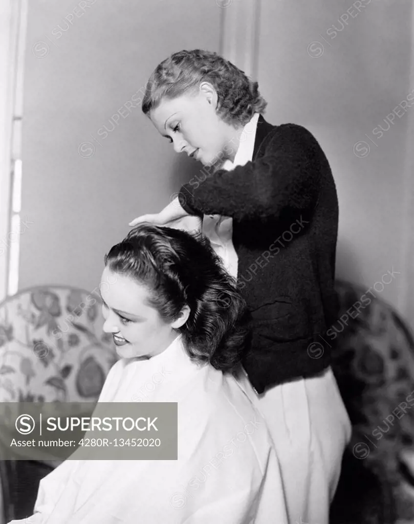 One woman doing an other woman´s hair All persons depicted are not longer living and no estate exists Supplier warranties that there will be no model ...