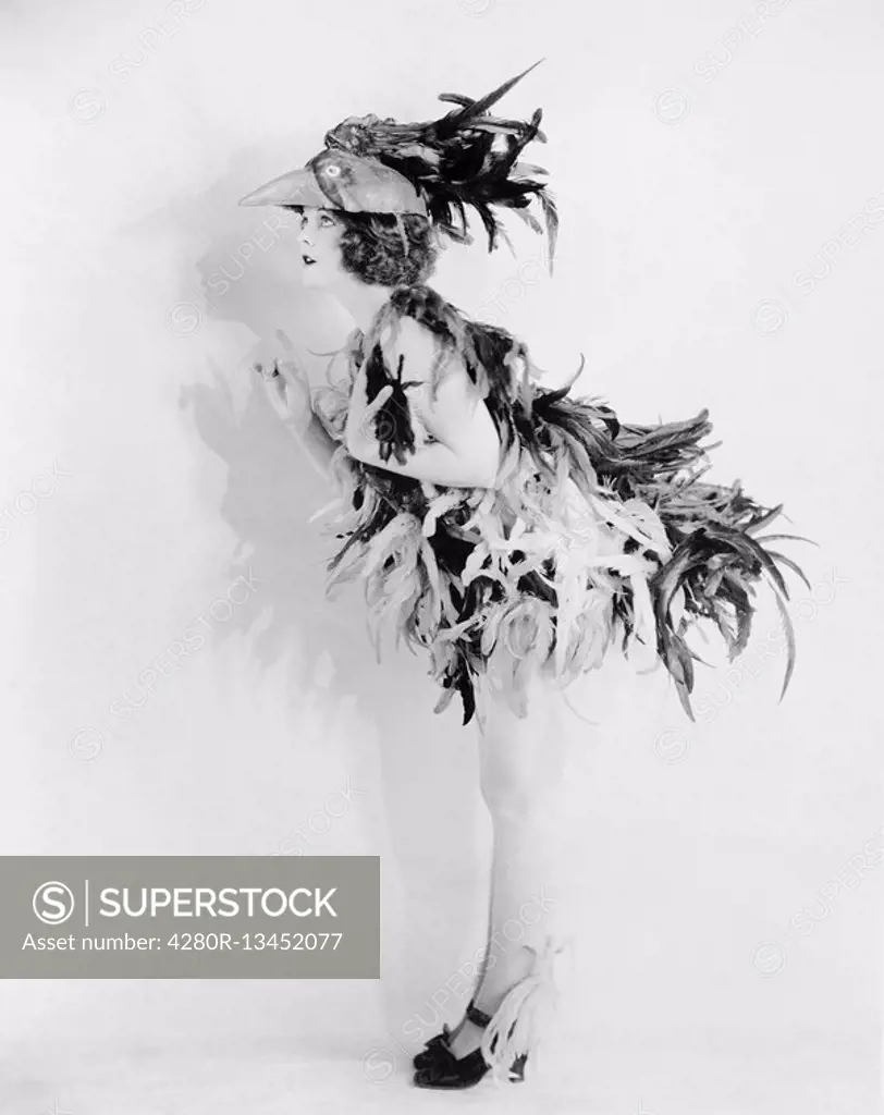 Young woman dressed like a bird is all feathered up and no place to go All persons depicted are not longer living and no estate exists Supplier warran...