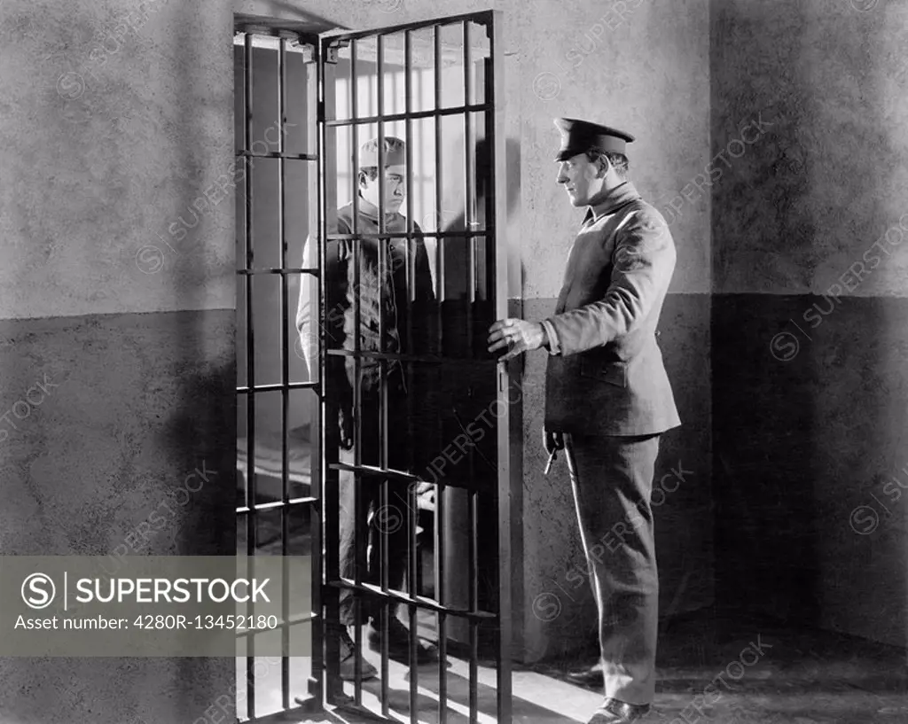 Policeman and prisoner in a jail cell All persons depicted are not longer living and no estate exists Supplier warranties that there will be no model ...