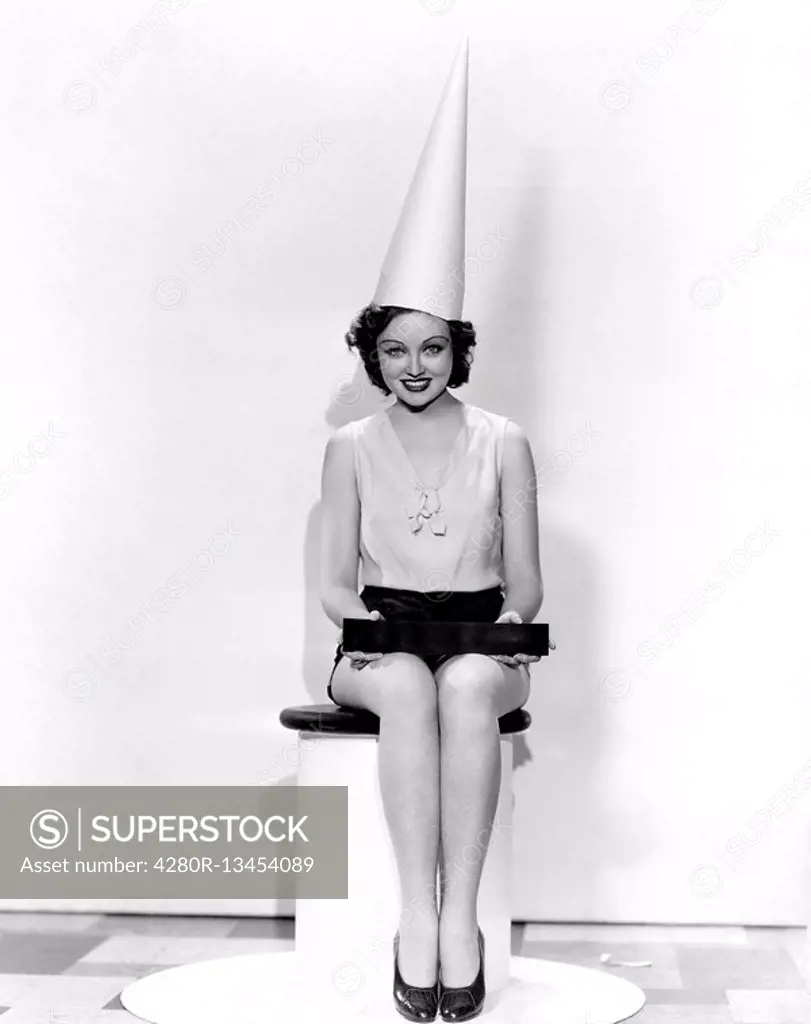 Portrait of woman with April Fool sign wearing dunce cap All persons depicted are not longer living and no estate exists Supplier warranties that ther...