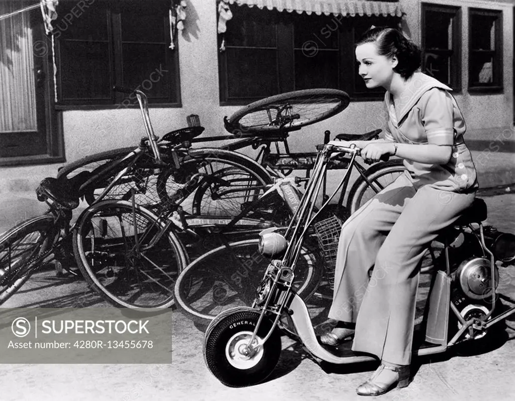 Leaving bicycles in the dust, a young woman fancies a miniature motorbike All persons depicted are not longer living and no estate exists Supplier war...