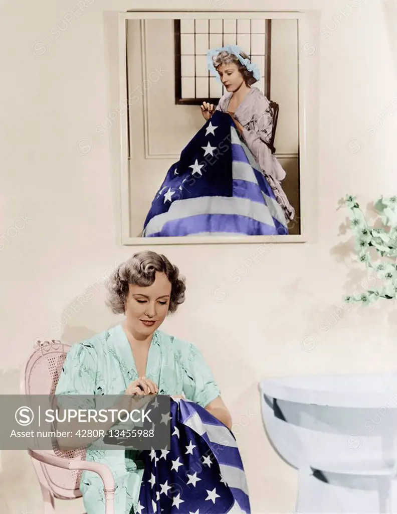 Woman sitting under the portrait of Betsy Ross sewing the American flag Old Visuals