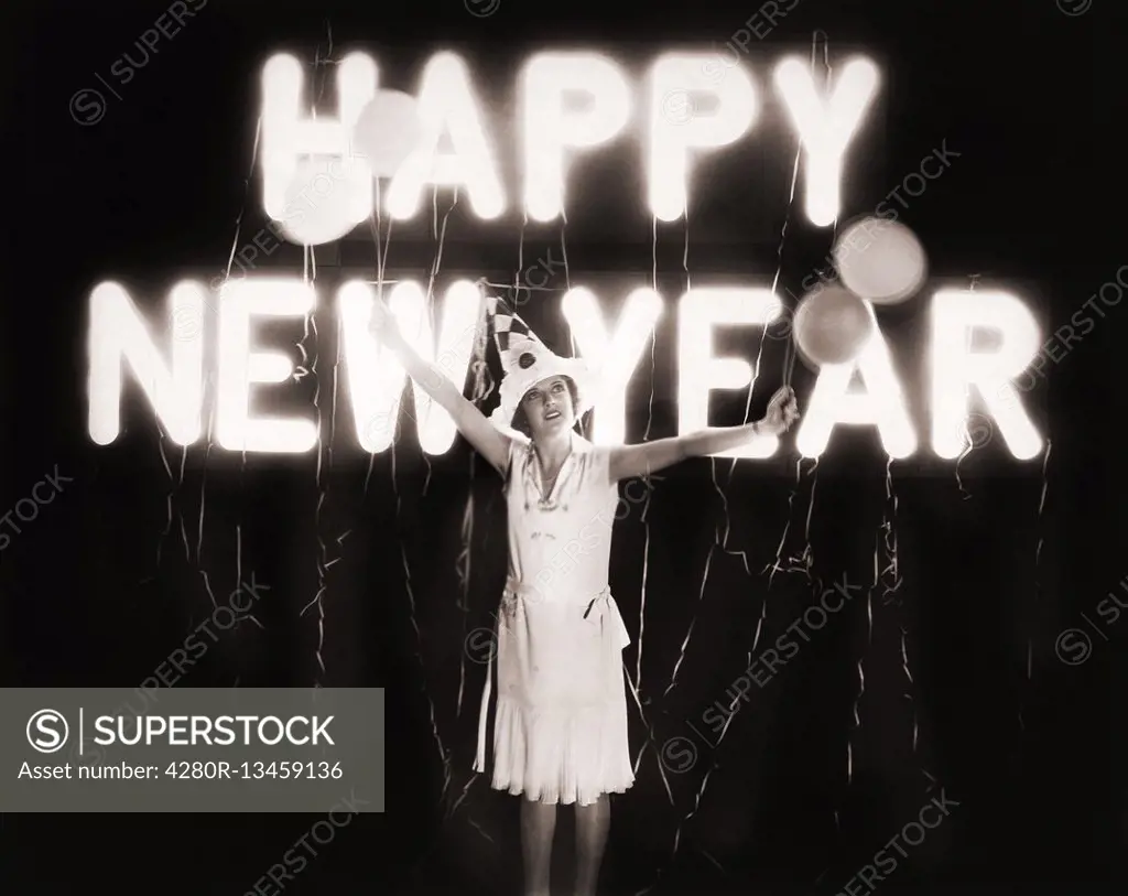 Woman standing in front of neon Happy New Year sign