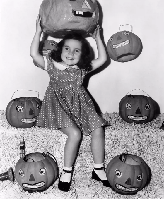 Smiling girl surrounded by jack-o'-lanterns (OV2019_615)