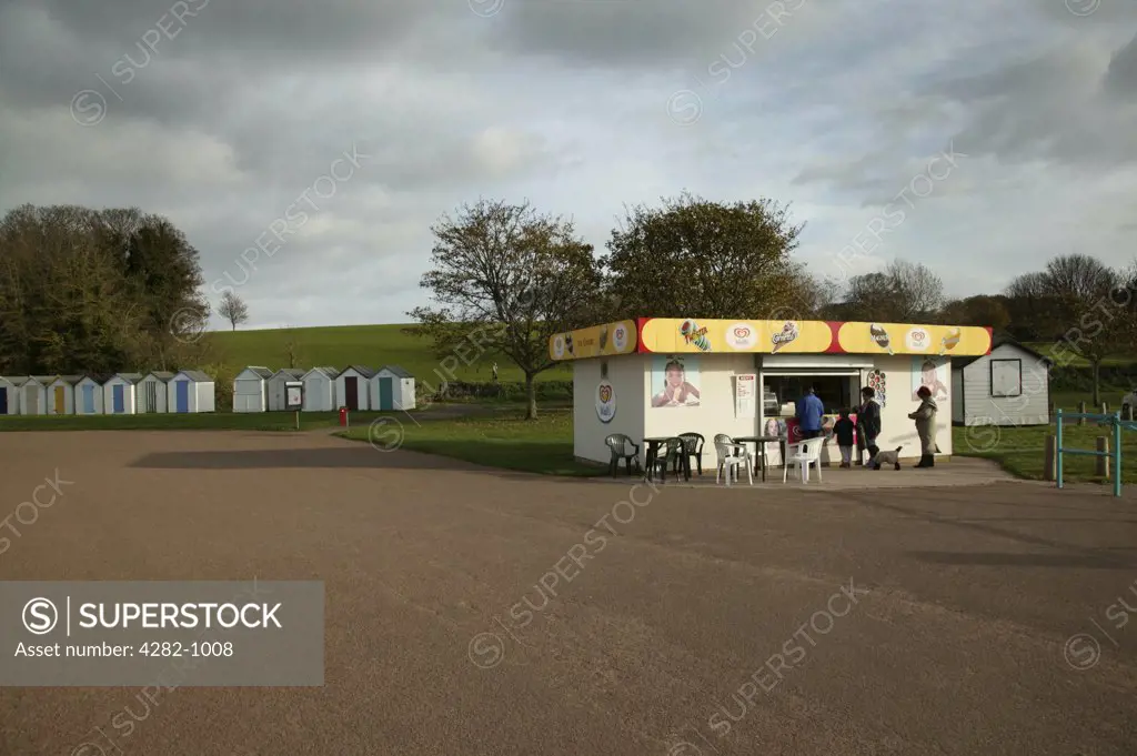 England, Devon, Broadsands. An ice cream parlour and beach huts on the English Riviera.