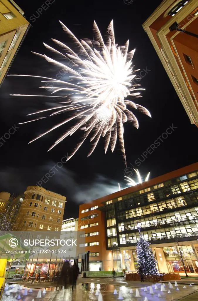 England, West Midlands, Birmingham. Christmas fireworks over Central Square at Brindleyplace in Birmingham.