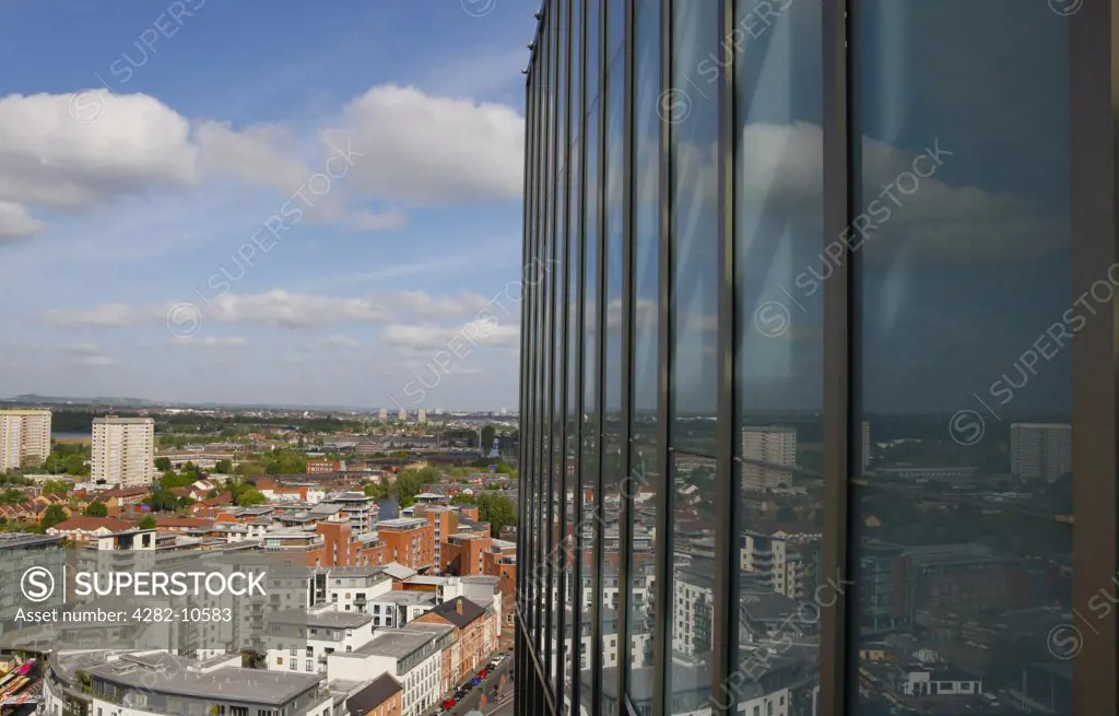 England, West Midlands, Birmingham. City skyline of Birmingham reflected in the glass cladding of 11 Brindleyplace, an award winning business and leisure destination in the heart of Birmingham city centre.