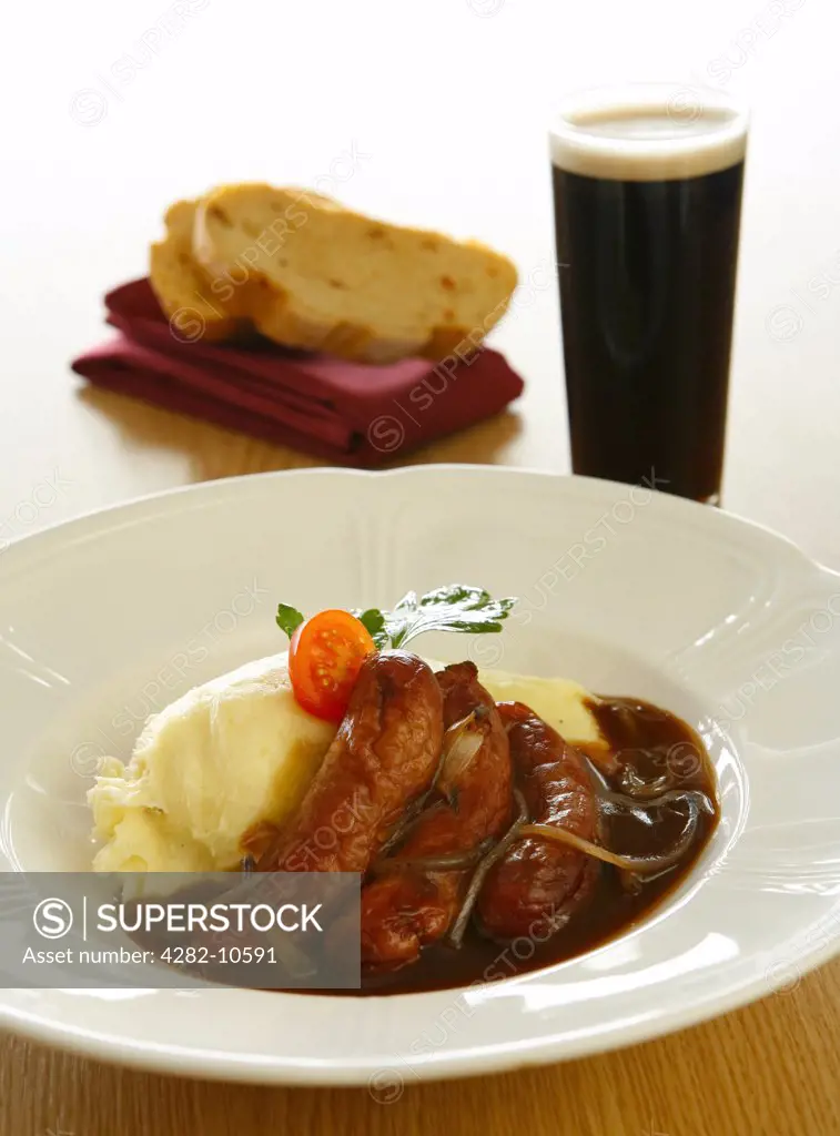 England, West Midlands, Birmingham. Sausage and mash with onion gravy, bread and a pint of Guinness.