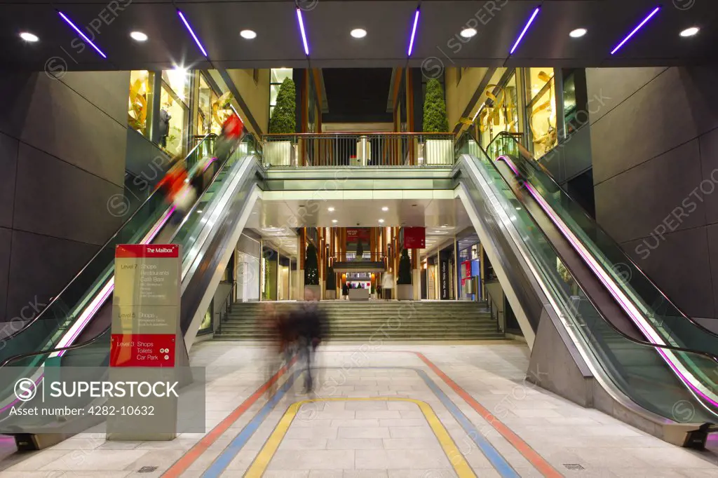 England, West Midlands, Birmingham. Escalators inside The Mailbox, a prestigious multi-million pound retail and lifestyle development on the site of a former Royal Mail sorting office in the centre of Birmingham.