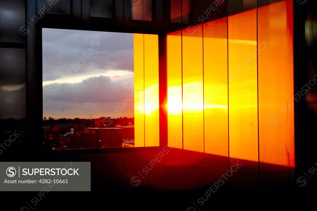 England, West Midlands, Walsall. Sunset reflecting of panels inside The New Art Gallery Walsall. The building was completed in 1999 and represents the largest built work of any British architect under 40 years of age.