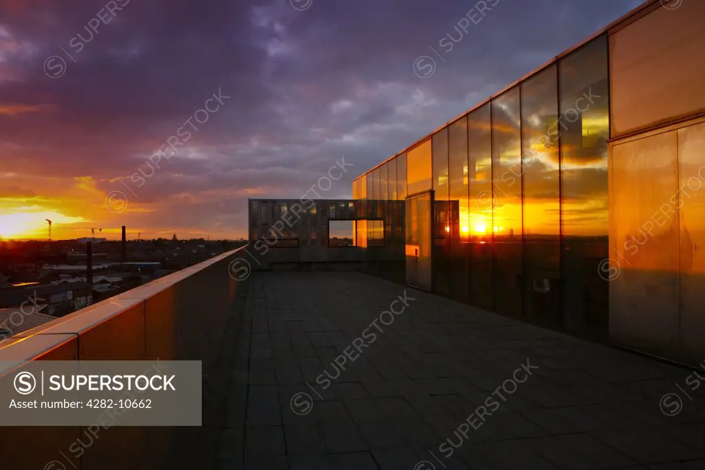 England, West Midlands, Walsall. Sunset reflected in windows of The New Art Gallery Walsall. The building was completed in 1999 and represents the largest built work of any British architect under 40 years of age.
