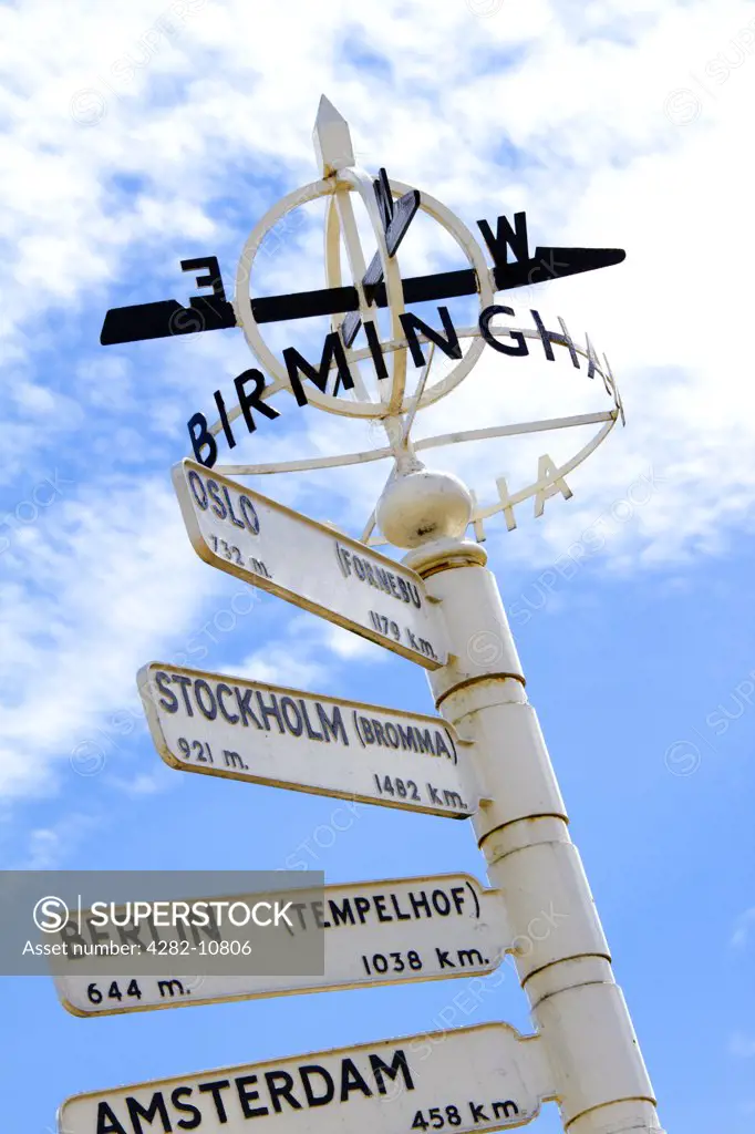 England, West Midlands, Birmingham. Finger post at Birmingham Airport, displaying distances and directions to international destinations.