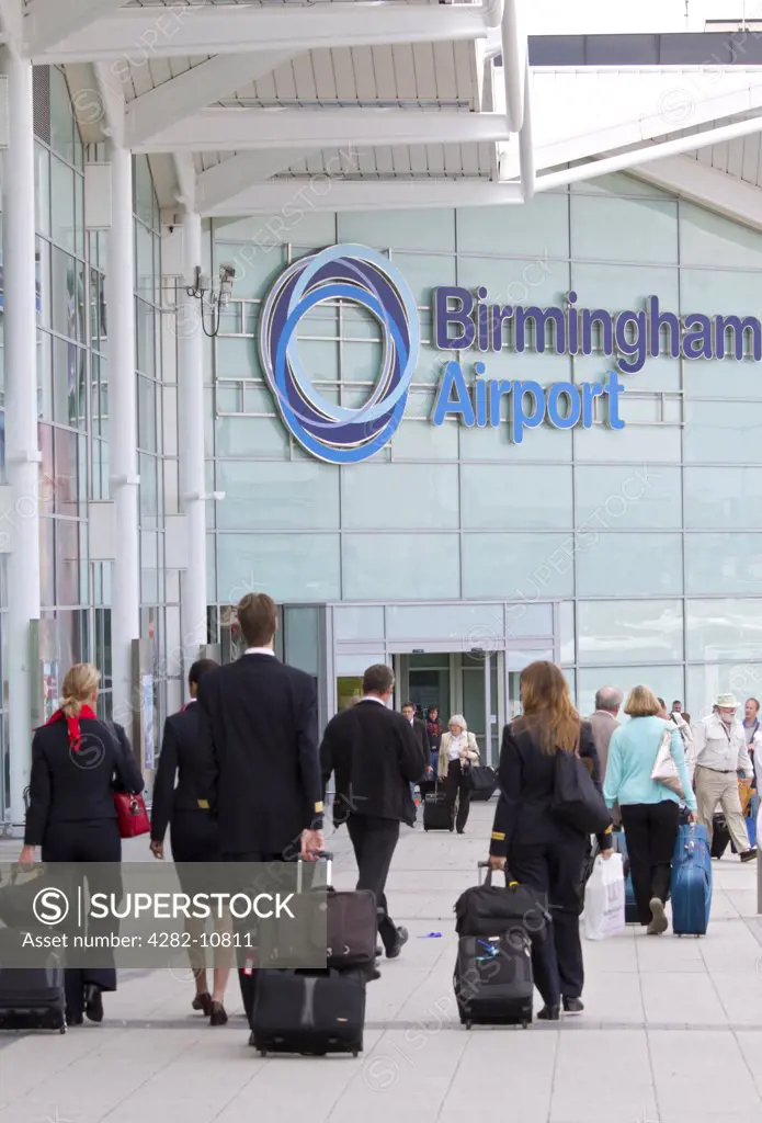 England, West Midlands, Birmingham. A flight crew arriving outside Birmingham Airport.