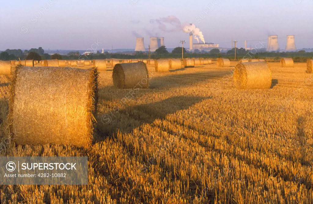 England, Oxfordshire, Didcot. Didcot Power Station and cornfield that has just been harvested.