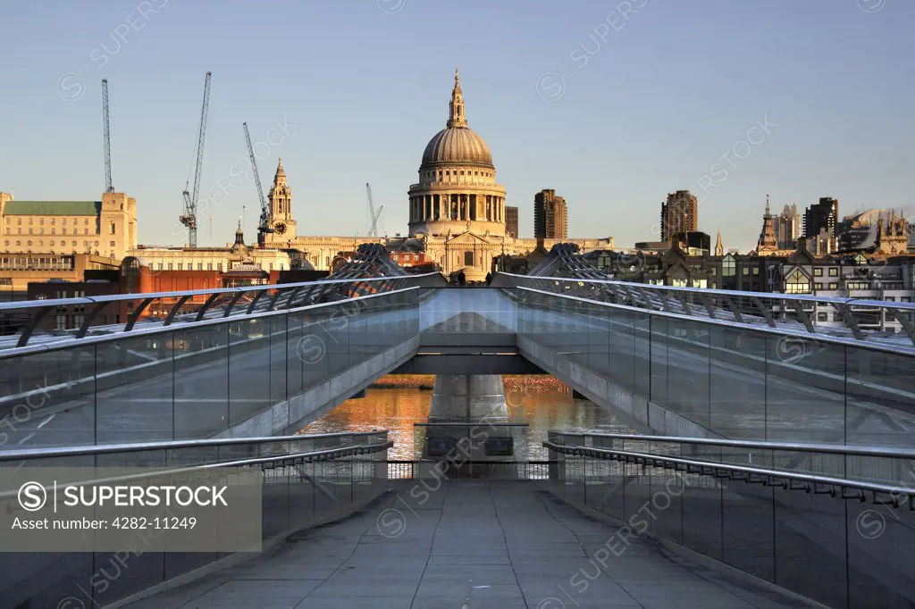 England, London, South Bank. St Paul's Cathedral and the Millennium Bridge at sunrise.