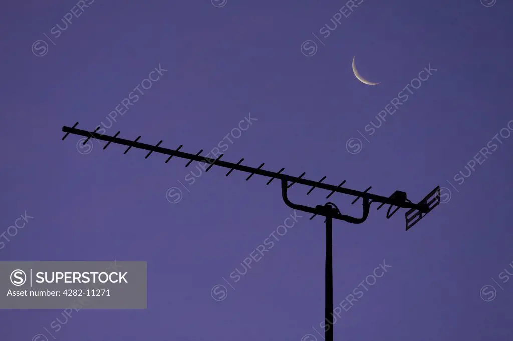 England, Oxfordshire, Radley. Detail of a TV aerial and a crescent moon.