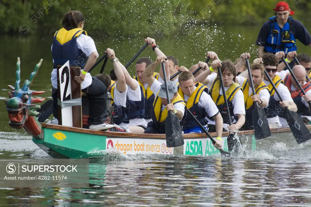 England, Oxfordshire, Abingdon. Dragon boat racing at the annual fund raising event on the River Thames at Abingdon.