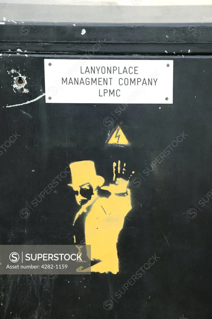 Northern Ireland, Belfast, Belfast. Graffiti below a Lanyonplace management company sign in Belfast.