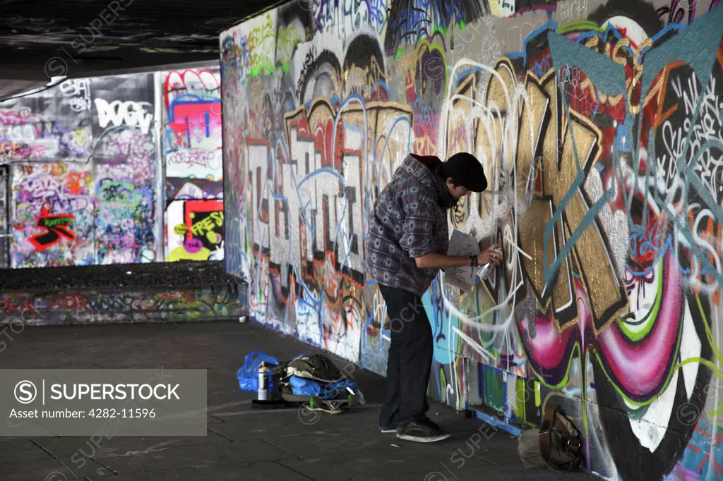 England, London, South Bank. A graffiti artist at work in an area known as the under-croft on the South Bank in London.