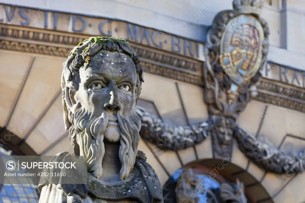 England, Oxfordshire, Oxford. The head of an 'Emperor', one of thirteen busts on top of pillars marking the front boundary of the Sheldonian Theatre. Each head shows a different type of beard.