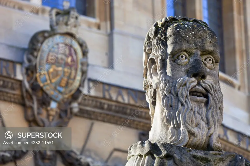 England, Oxfordshire, Oxford. The head of an 'Emperor', one of thirteen busts on top of pillars marking the front boundary of the Sheldonian Theatre. Each head shows a different type of beard.