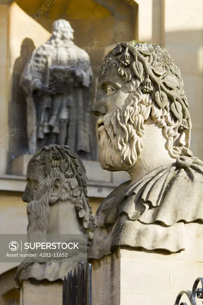 England, Oxfordshire, Oxford. The heads of an 'Emperors', two of thirteen busts on top of pillars marking the front boundary of the Sheldonian Theatre. Each head shows a different type of beard.