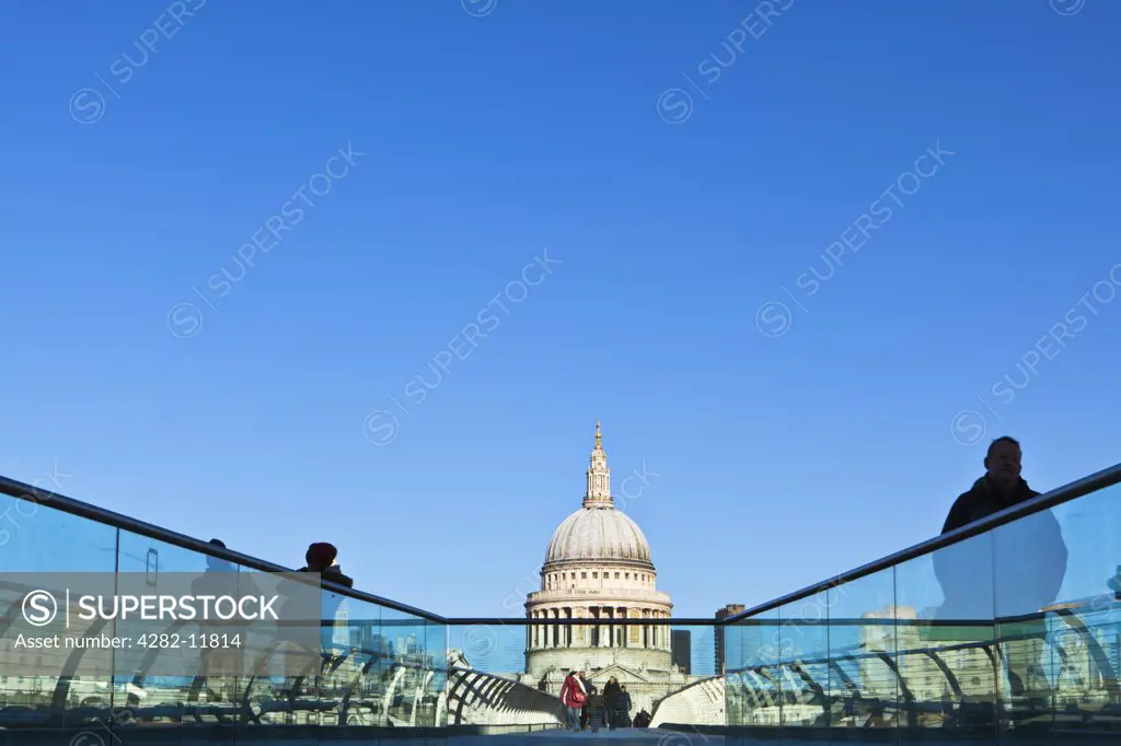 England, London, City of London. View of people crossing the Millennium Bridge from Bankside, looking towards St. Paul's Cathedral on the North side of the River Thames.