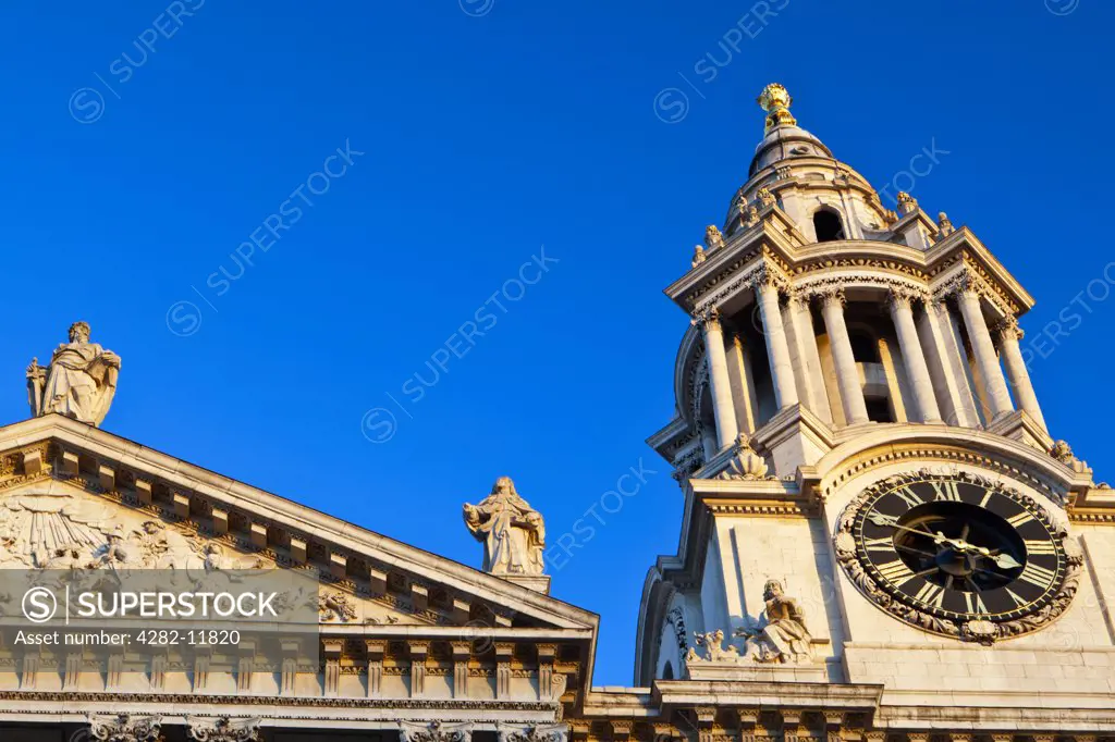 England, London, City of London. Clocktower and top of the portico of the west end of St Paul's Cathedral, designed by Sir Christopher Wren in the 17th century.