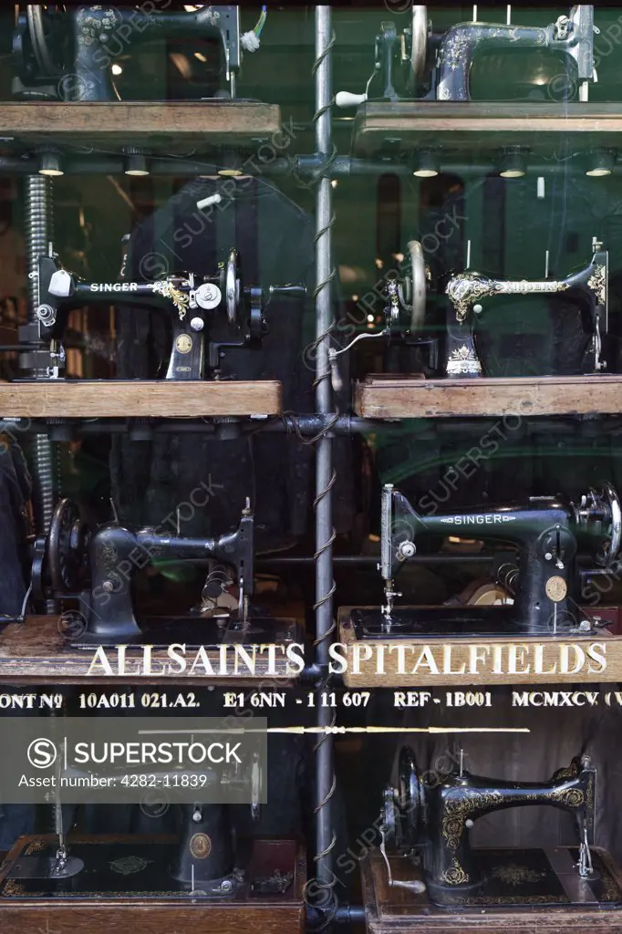 England, London, Notting Hill. Sewing machines in the window display of All Saint's Spitalfields in Westbourne Grove.