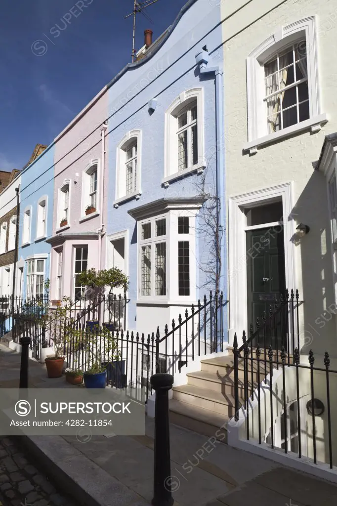 England, London, Kensington. Pastel coloured terrace houses in Bywater Street.