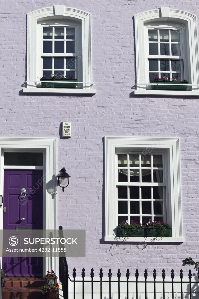 England, London, Kensington. The exterior of a lilac painted terrace house in Bywater Street.