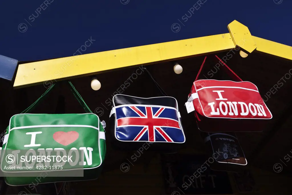 England, London, Camden. Holdalls with I Love London and a Union Jack emblazoned on them for sale from a shop in Camden.