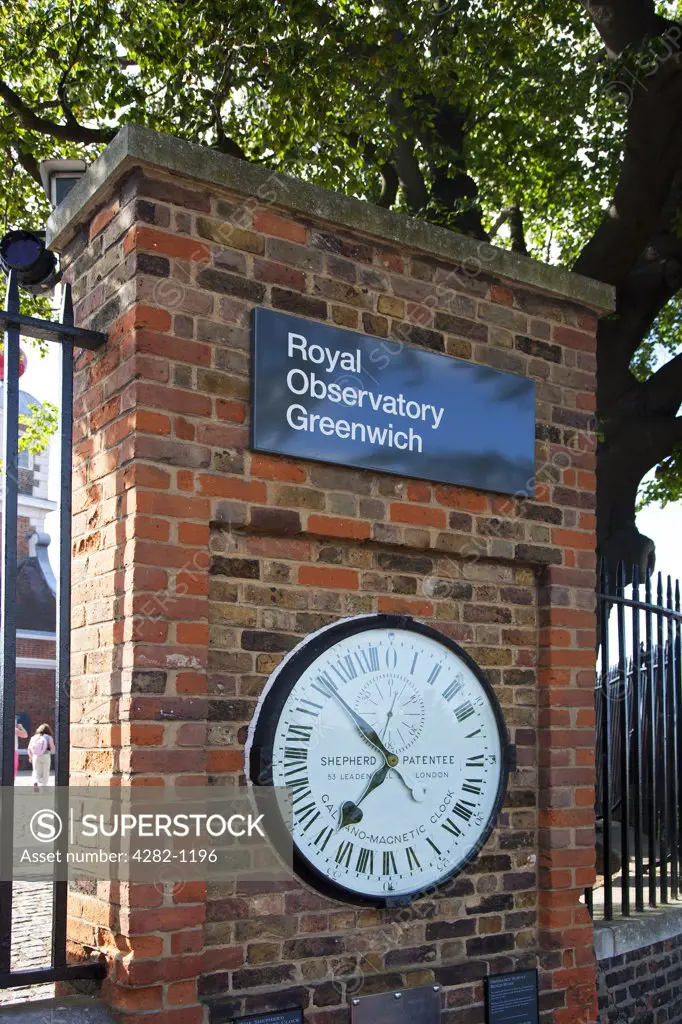 England, London, Greenwich. The Shepherd Gate Clock on a wall outside the Royal Observatory Greenwich. The clock was probably the first to display Greenwich Mean Time (GMT).