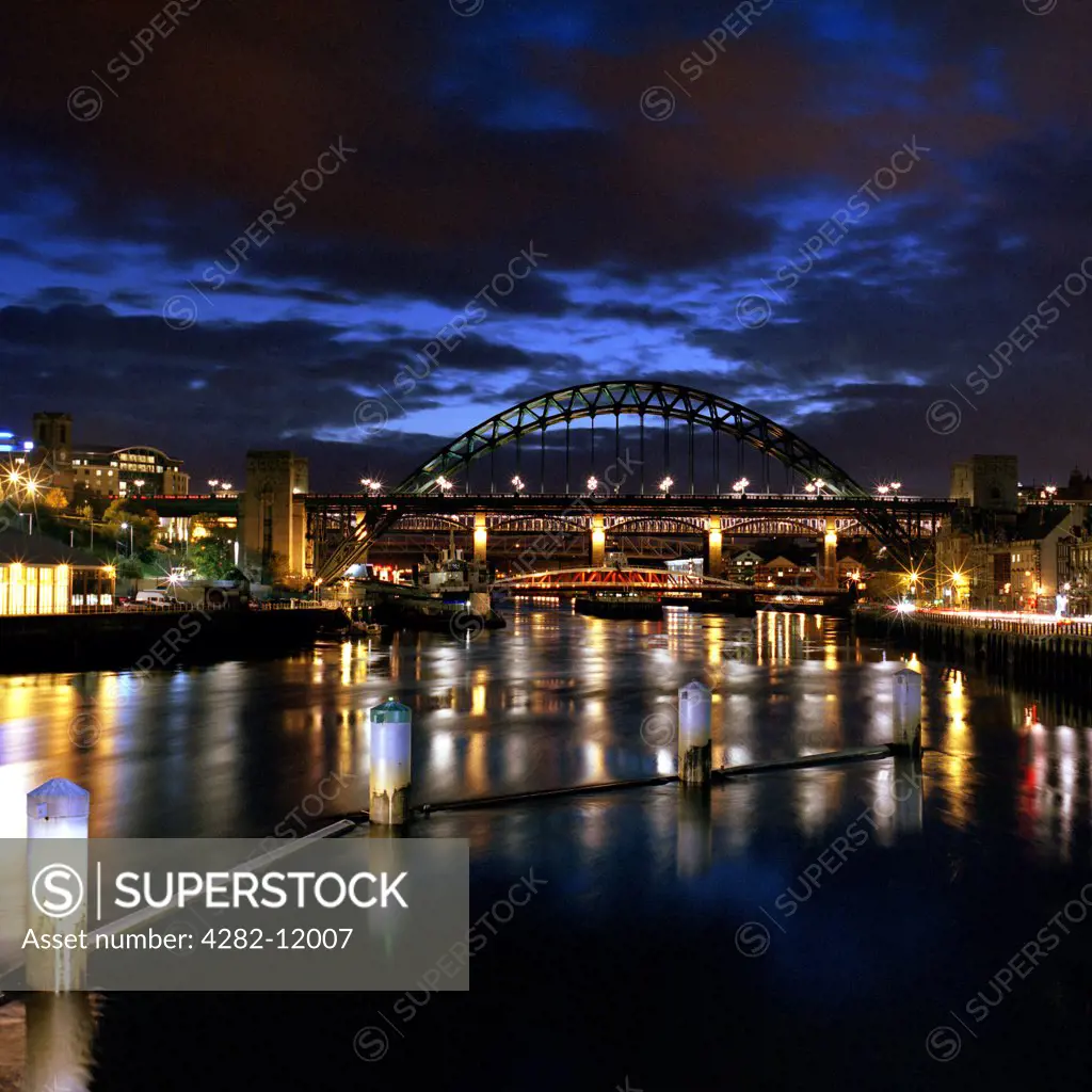 England, Tyne and Wear, Tyne Bridge. The Tyne Bridge at night. The bridge is a fine example of a compression arch suspended-deck bridge and was officially opened in 1928 by King George V.