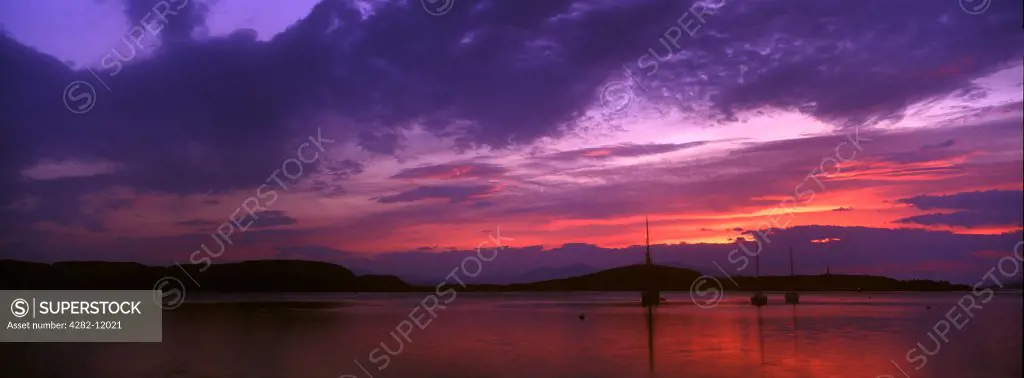 Scotland, Argyll and Bute, Oban. The pinks and reds of a west coast sunset looking towards the western isles.