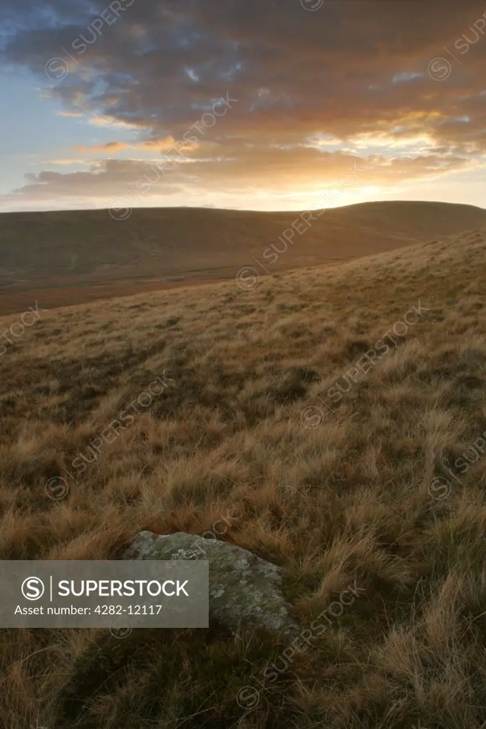 England, Cumbria, Caldbeck Common. The soft hues of a sunset behind the hills of Caldbeck Common.
