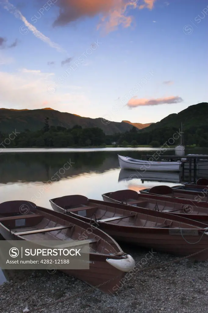England, Cumbria, Ullswater. Rowing boats and the sweeping vista of Ullswater which is part of the Lake District National Park.