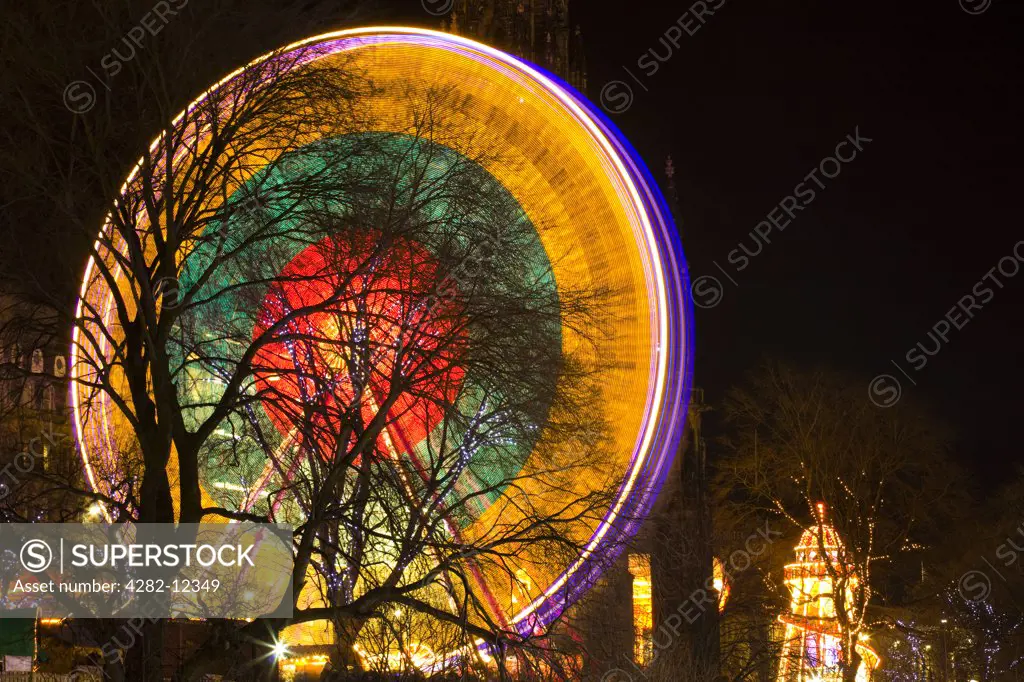 Scotland, City of Edinburgh, Edinburgh. Ferris wheel located near the Scott Monument in East Princes Street Gardens in Edinburgh as part of the Christmas Fair.