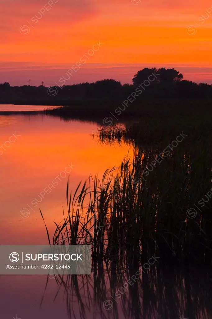 England, Tyne and Wear, Big Waters Country Park. Sunset over the lake in Big Waters Country Park. The lake is a a subsidence pond, formed by the collapse of old mine workings.