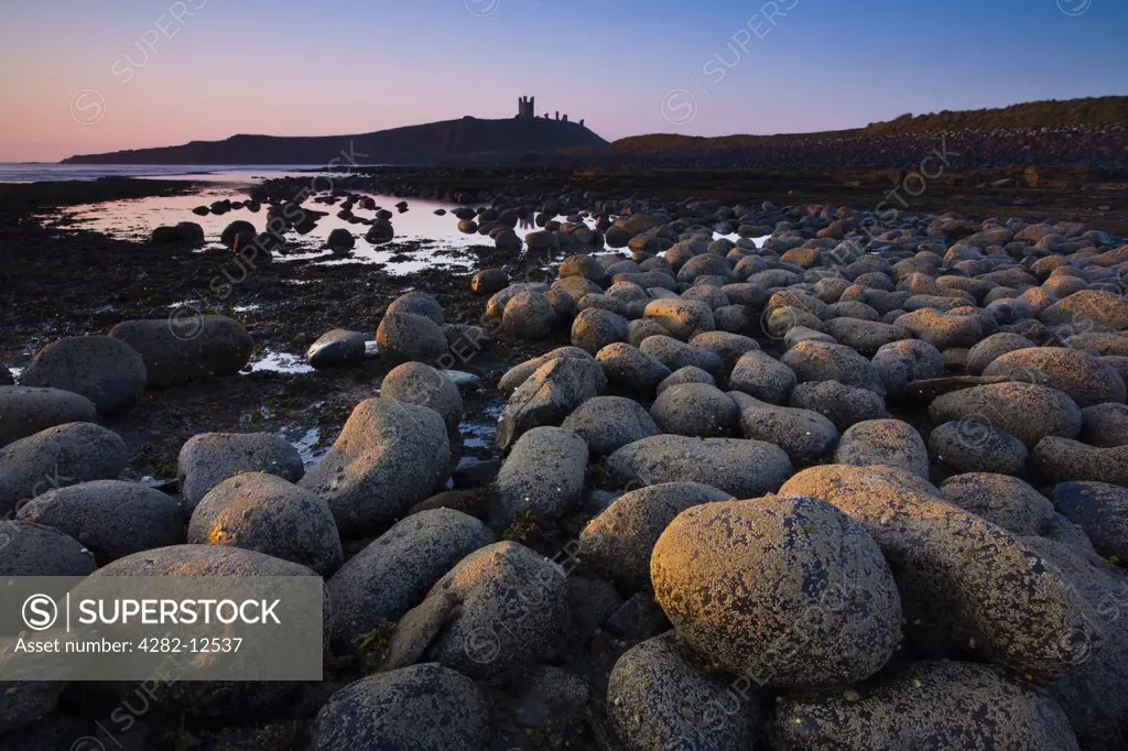 England, Northumberland, Embleton Bay. Weathered rocks dominate the low-tide shoreline of Embleton Bay.