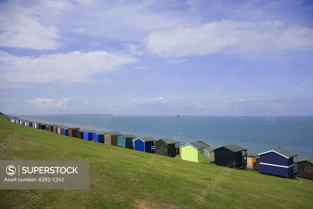 England, Kent, Whitstable. Beach huts along the seafront at Whitstable.