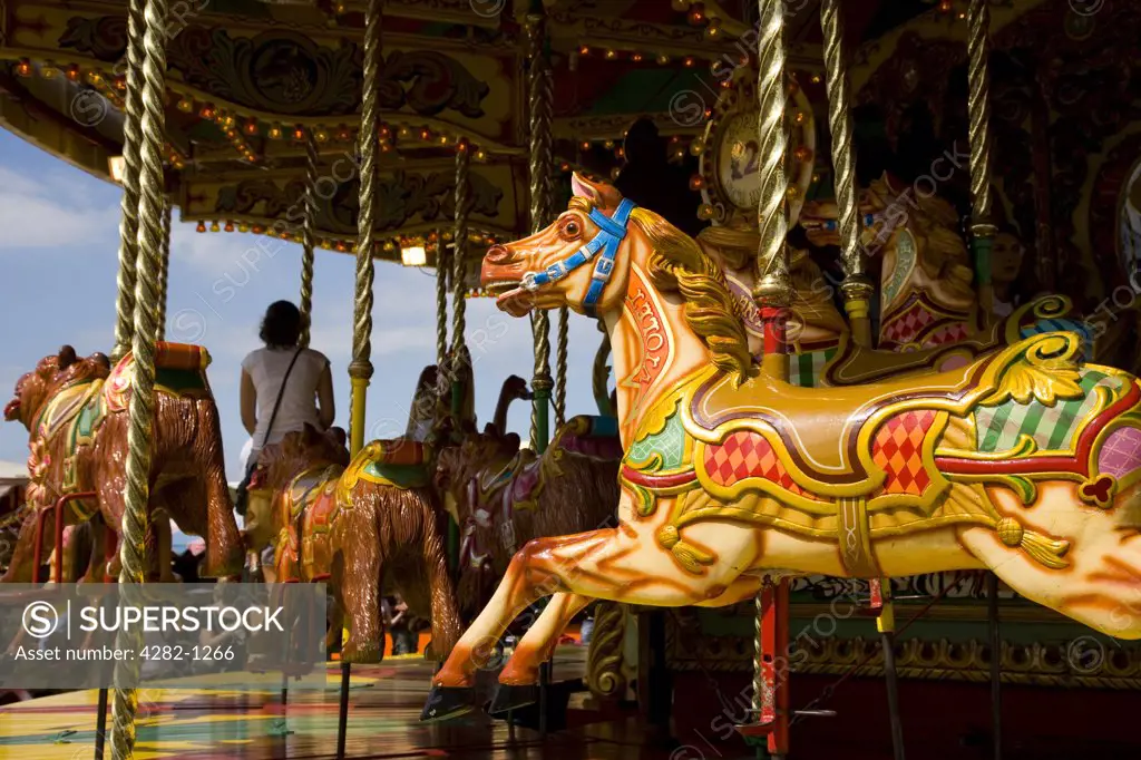 England, Kent, Whitstable. A painted horse on a traditional carousel at a fair in Whitstable.