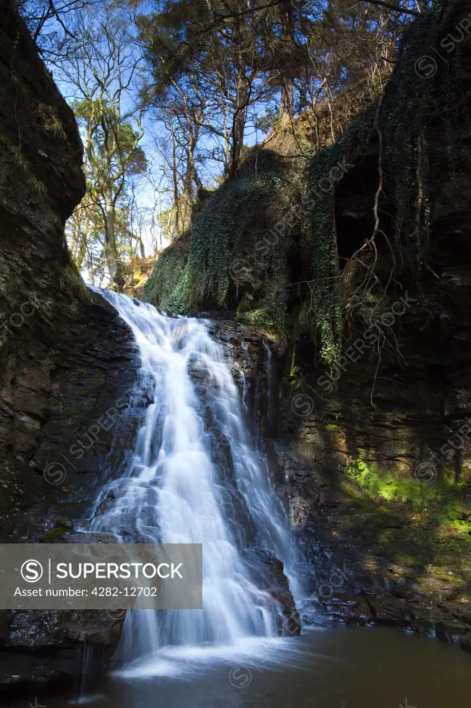 England, Northumberland, near Bellingham. Hareshaw Linn is a spectacular waterfall located in a steep sided gorge, which continues to flow through a wooded valley. Hareshaw Linn is located near Bellingham within the Northumberland National Park.